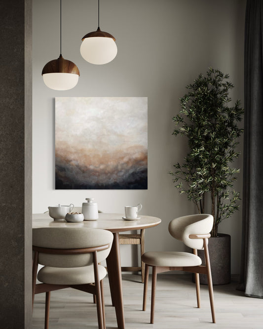 Handmålad tavla Gryning av Elin Palmgren i vit, beige, koppar och svart, som hänger i en matsal med matbord och stolar
